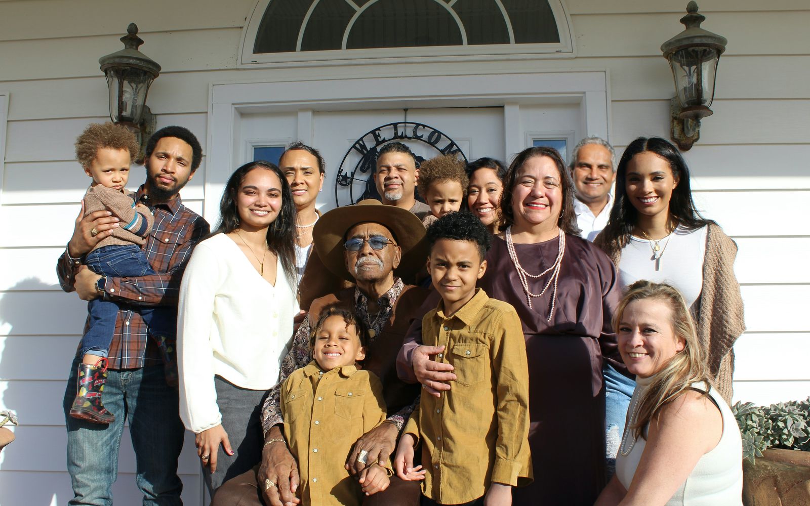 Four generations of one family gathered on the front porch of their home.